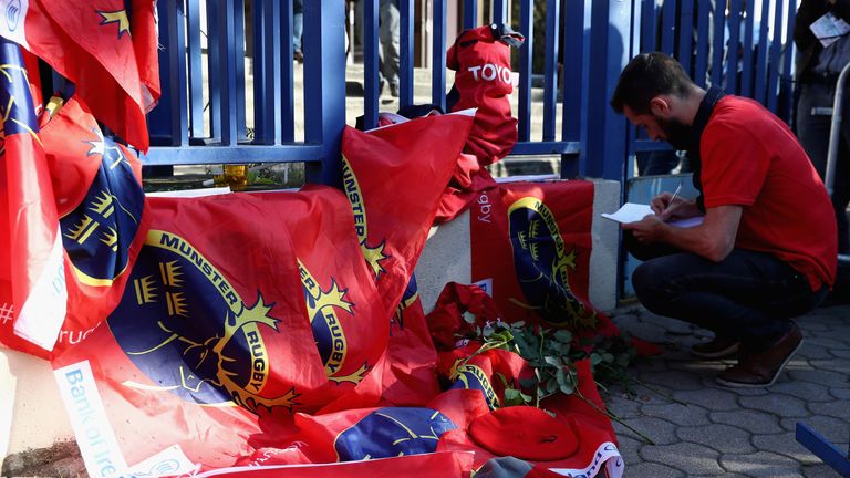 PARIS, FRANCE - OCTOBER 16:  A Munster fan signs a book of condolence after hearing of the news of the death of Munster coach Anthony Foley prior to the Eu