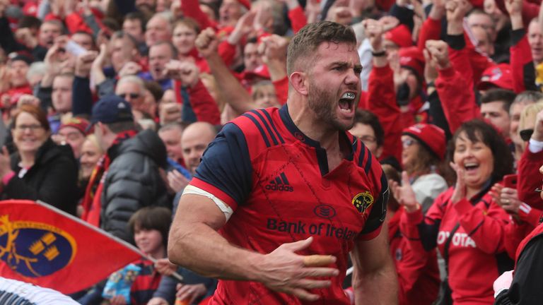 Munster 's Jaco Taute celebrates scoring a try