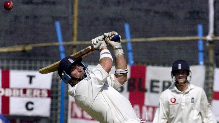 CHITTAGONG, BANGLADESH:  England batsman Nasser Hussain (L) attempts to hit a ball as team mate Chris Read  (R, background) looks on during the second day 