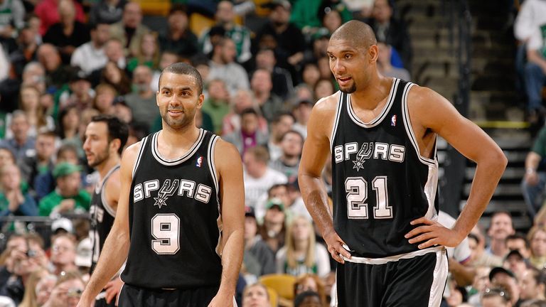 Tony Parker #9 and Tim Duncan #21 of the San Antonio Spurs rest on the court