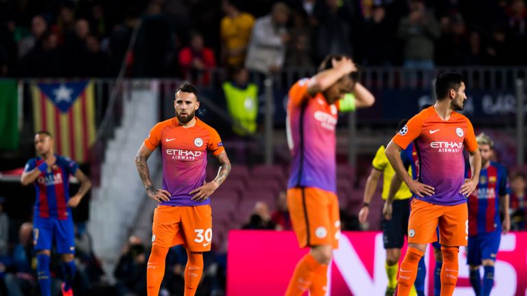 BARCELONA, SPAIN - OCTOBER 19: Nicolas Otamendi (L) and Ilkay Gundogan (R) of Manchester City FC look dejected after FC Barcelona scored a goal during the 