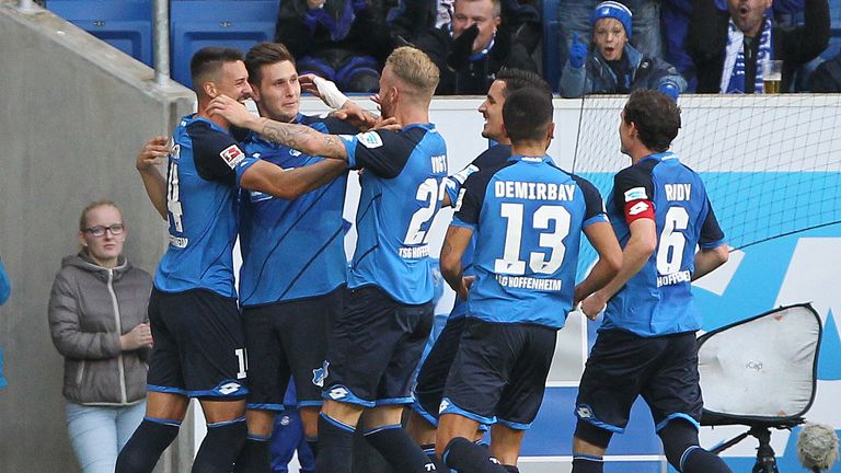 Hoffenheim's defender Niklas Suele (2L) celebrates scoring the 1-0 with teammates during the German first division Bundesliga football match between TSG 18