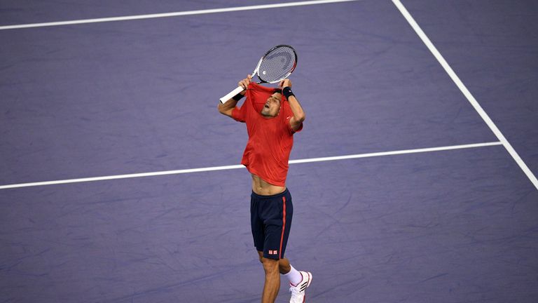 Novak Djokovic rips his shirt after losing a point against Roberto Bautista Agut