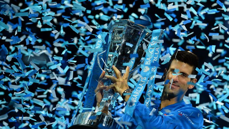 Serbia's Novak Djokovic holds up the ATP trophy after winning the men's singles final match against Switzerland's Roger Federer