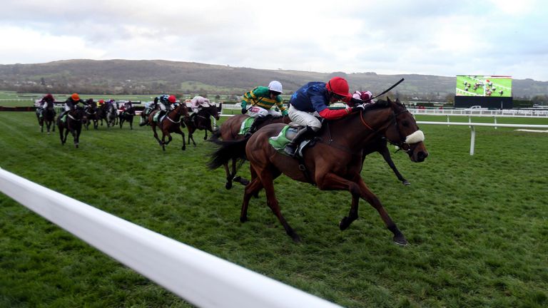 Old Guard ridden by Harry Cobden (red cap) on their way to victory in the StanJames.com Greatwood Hurdle at Cheltenham