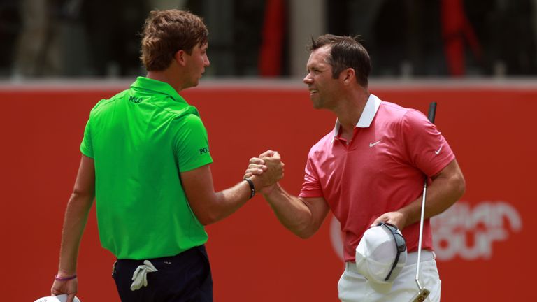 KUALA LUMPUR, MALAYSIA - OCTOBER 20:  Paul Casey of England shakes hands with Kaufman Smylie of the United States on the 18th hole during day one of the 20