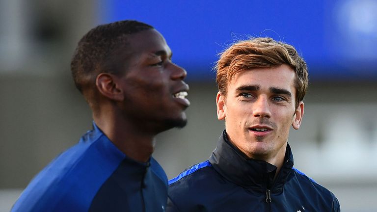 France's forward Antoine Griezmann (R) speaks to France's midfielder Paul Pogba during a training session in Clairefontaine-en-Yvelines near Paris on Octob
