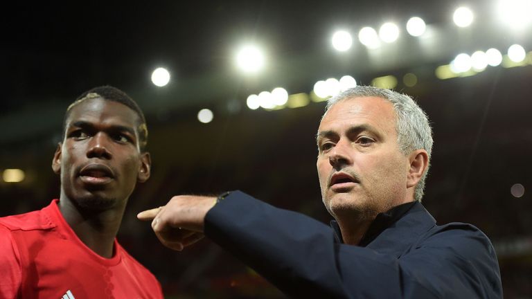 Manchester United's Portuguese manager Jose Mourinho (R) gestures to Manchester United's French midfielder Paul Pogba 