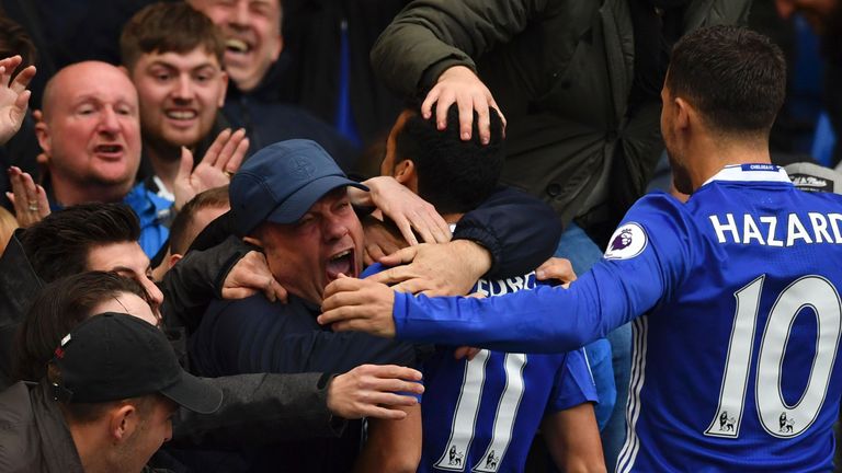 Chelsea's Spanish midfielder Pedro goes into the crowd to celebrate after scoring the opening goal of the English Premier League football match between Che