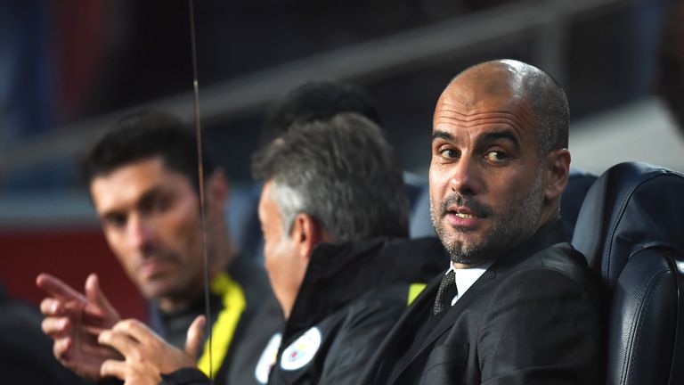 Pep Guardiola looks on from the away bench at Camp Nou
