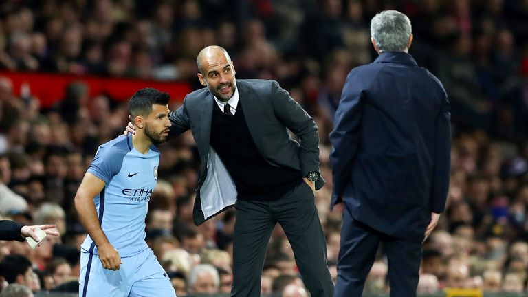 Sergio Aguero prepares to come on while receiving instructions from Pep Guardiola