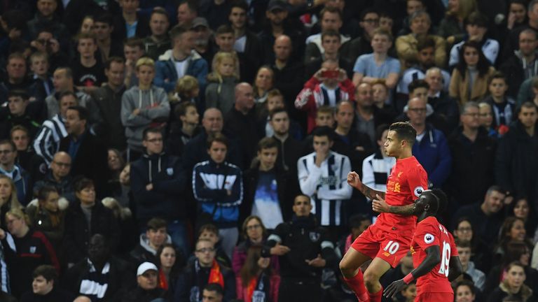 Liverpool's Brazilian midfielder Philippe Coutinho (L) celebrates after scoring