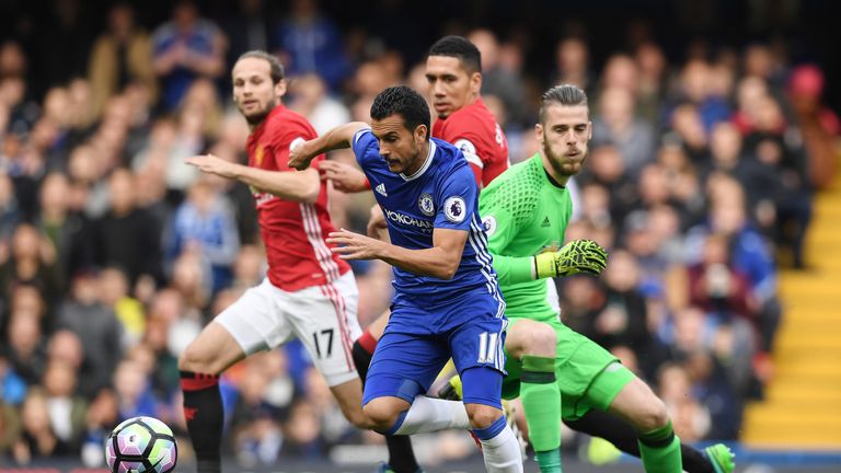 Pedro takes the ball around David De Gea to score Chelsea's first goal