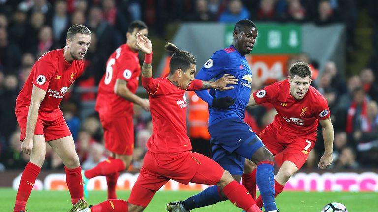 Paul Pogba battles for possesion with Roberto Firmino and James Milner at Anfield