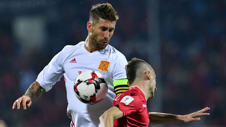 Spain's Sergio Ramos (L) vies with Albania's Ansi Agolli during the FIFA World Cup 2018 qualification football match Albania vs Spain at the Loro-Borici st