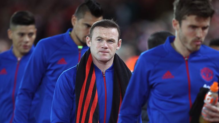 Wayne Rooney walks to the away team bench at Anfield