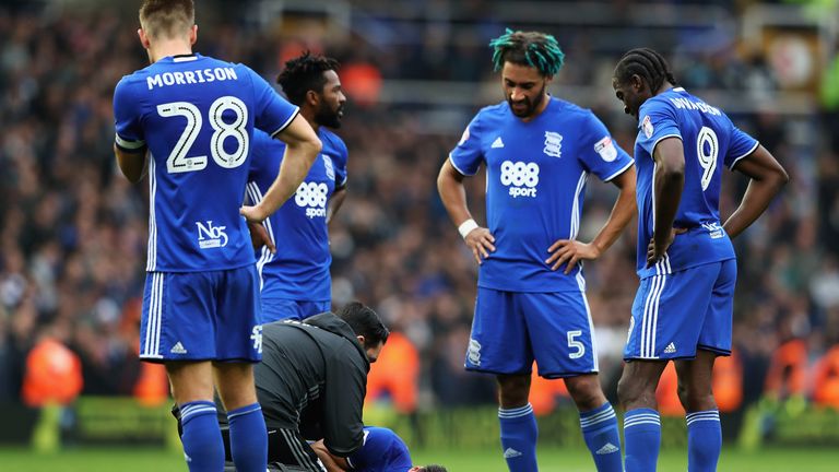 Birmingham City players look on as Rhoys Wiggins lays injured