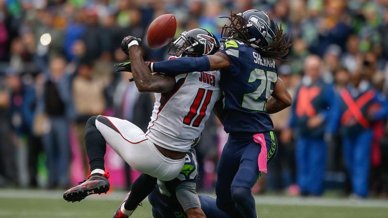 SEATTLE, WA - OCTOBER 16:  Wide receiver Julio Jones #11 of the Atlanta Falcons can't make the catch on fourth down as cornerback Richard Sherman #25 of th