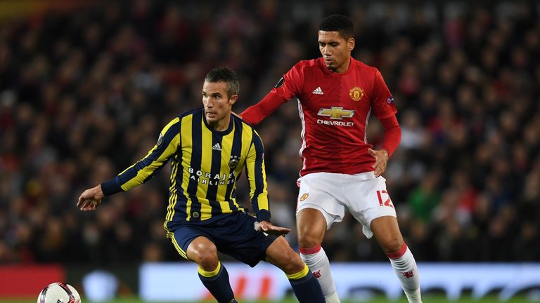 MANCHESTER, ENGLAND - OCTOBER 20:  Robin van Persie of Fenerbahce is closed down by Chris Smalling of Manchester United  during the UEFA Europa League Grou