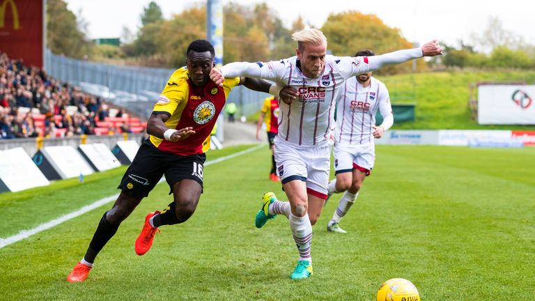 Partick's Ade Azeez (L) in action against Andrew Davies