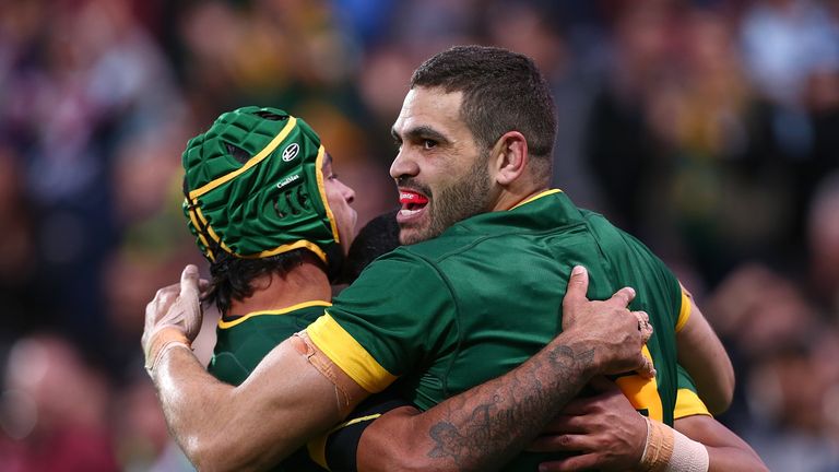 Johnathan Thurston, Greg Inglis and Valentine Holmes of Australia celebrate a try against New Zealand