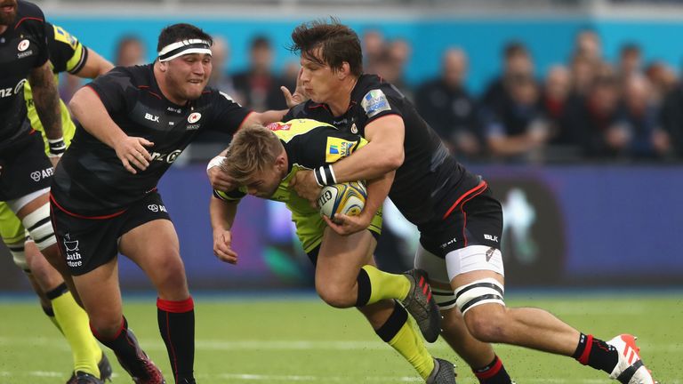 Jack Roberts of Leicester is tackled by Michael Rhodes (right) and Jamie George