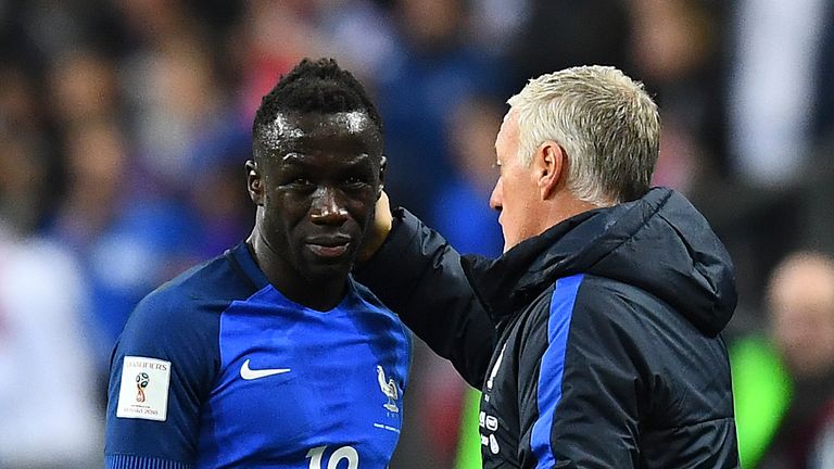 France's head coach Didier Deschamps (R) taps France's defender Bacary Sagna as he leaves the pitch following an injury during the FIFA World Cup 2018 qual