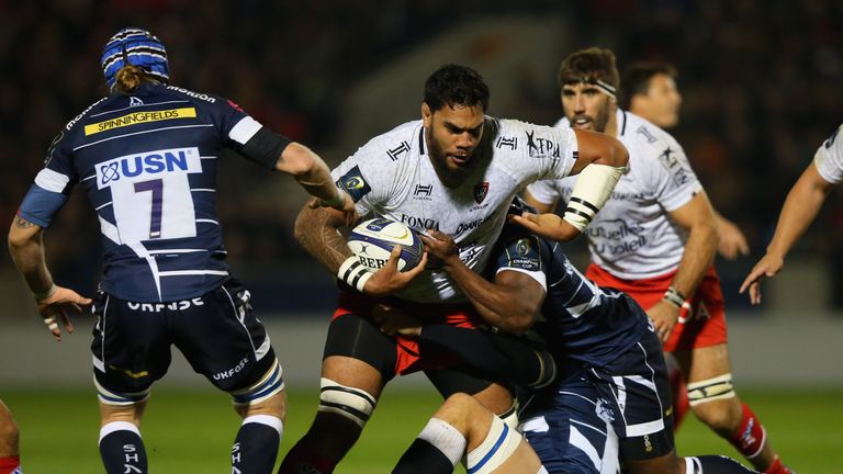 SALFORD, ENGLAND - OCTOBER 21:  Romain Taofifenua of RC Toulon is tackled by Brian Mujati and Andrei Ostrikov of Sale Sharks during the European Rugby Cham
