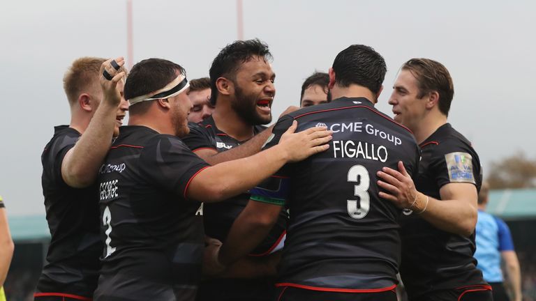 Billy Vunipola celebrates with team-mates after scoring