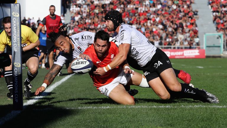 Sean Maitland of Saracens dives over for the first try despite being tackled by Ma'a Nonu (L) and Leigh Halfpenny during the Champions Cup opener