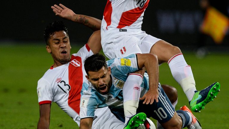 Argentina's Sergio Aguero (C) vies for the ball with Peru's Renato Tapia (L) and Cristian Benavente Bristol during their Russia 2018 World Cup qualifier fo