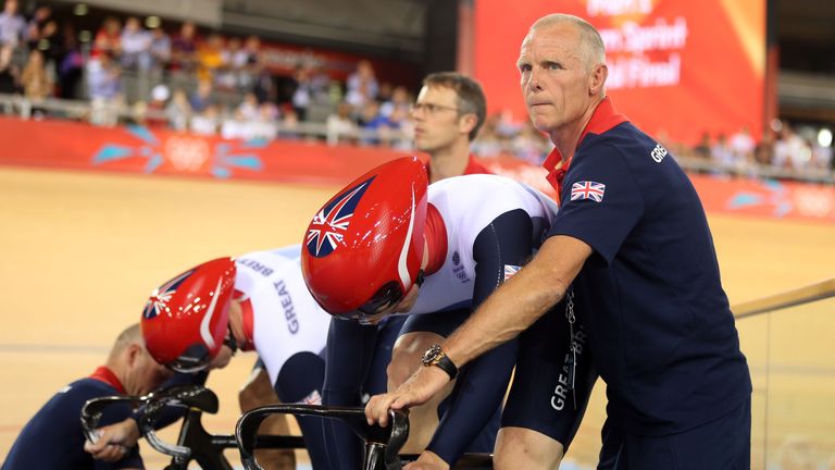 LONDON, ENGLAND - AUGUST 02:  Jason Kenny (R) and Philip Hindes of Great Britain prepare their bikes with the assistance of coaches Shane Sutton and Jan va