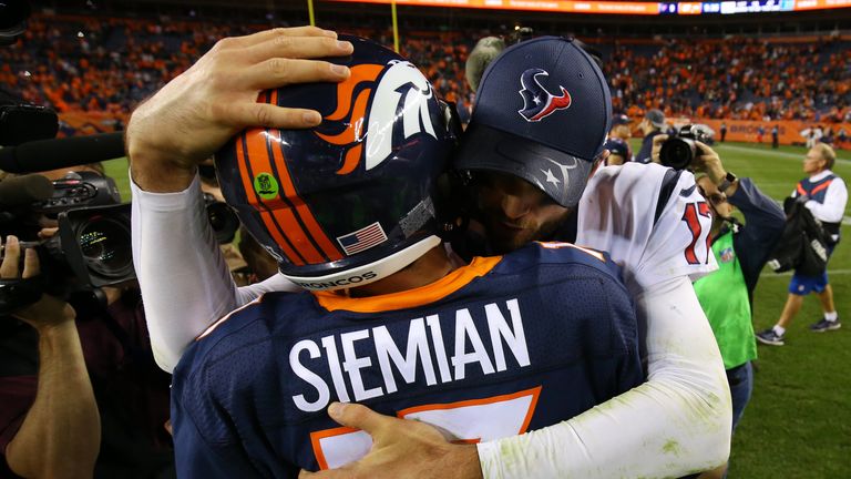 DENVER, CO - OCTOBER 24:  Quarterback Brock Osweiler #17 of the Houston Texans hugs quarterback Trevor Siemian #13 of the Denver Broncos after the Broncos 