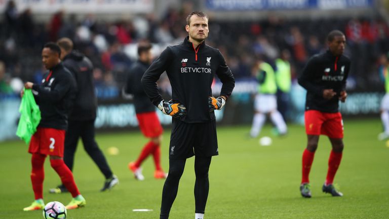 Simon Mignolet of Liverpool warms up in the rain prior to kick off during the Premier League match between Swansea City