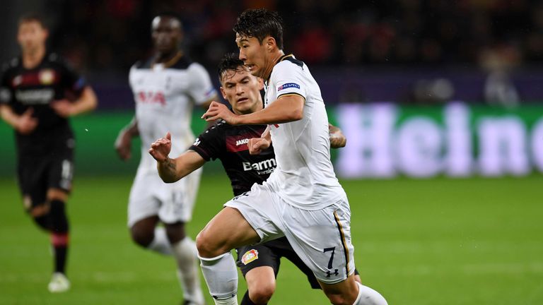 Leverkusen's Charles Aranguiz makes a challenge on Son Heung-Min of Tottenham