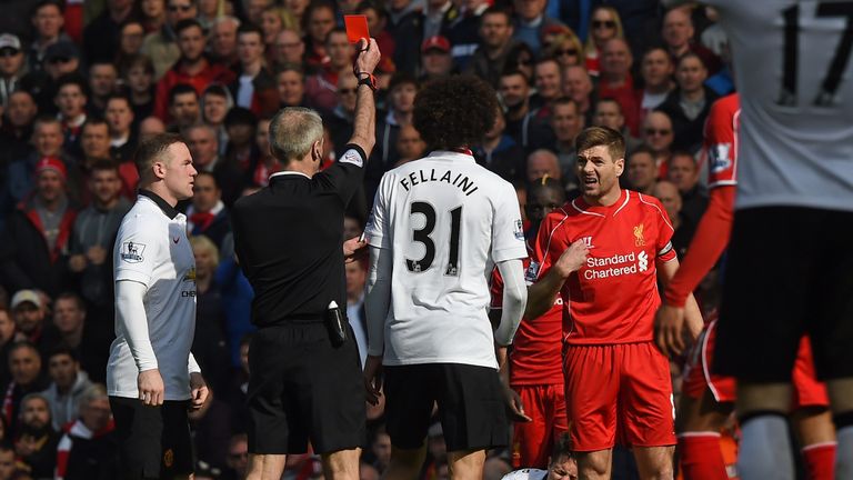 Liverpool's English midfielder Steven Gerrard is shown a red card by referee Martin Atkinson (2nd L) in the first minute of the second half, after coming o