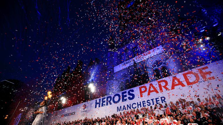 Ticker tape fills the air as members of Team GB celebrate on stage outside Manchester Town Hall in Albert Square