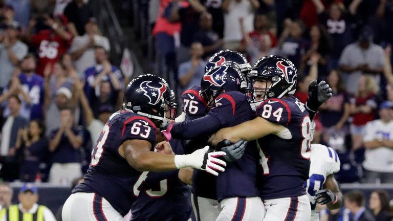 HOUSTON, TX - OCTOBER 16: Nick Novak #8 of the Houston Texans is mobbed by Ryan Griffin #84 and Kendall Lamm #63 after kicking a 33 yard game winning field