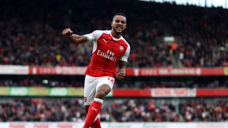 Theo Walcott of Arsenal celebrates after doubling his tally against Swansea