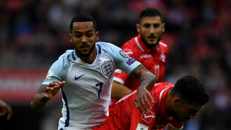 Theo Walcott is fouled by Zach Muscat of Malta 