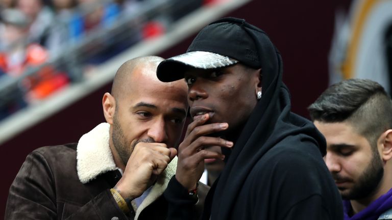 Manchester United's Paul Pogba (right) and Thierry Henry during the NFL International Series match at Wembley Stadium, London.