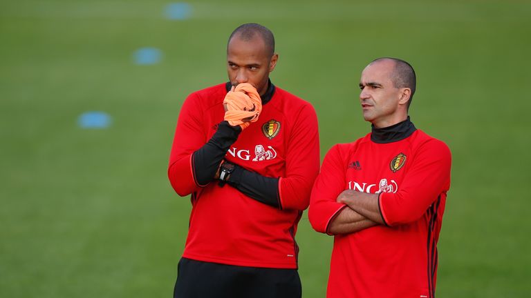 Belgium's assistant coach Thierry Henry (L) talks to Belgium's head coach Roberto Martinez during a training session in Tubize on October 3, 2016, ahead of