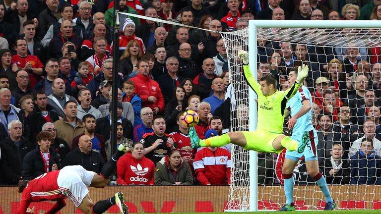 Tom Heaton of Burnley (R) saves a shot