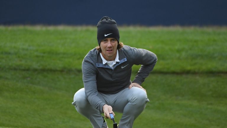 WATFORD, ENGLAND - OCTOBER 13:  Tommy Fleetwood of England lines up a putt on the 18th green during the first round of the British Masters at The Grove on 