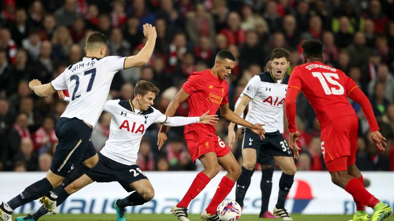 Liverpool's Trent Alexander-Arnold (centre) holds off Tottenham Hotspur's Tom Carroll (left) and Ben Davies (right) during the EFL Cup, round of 16 match a