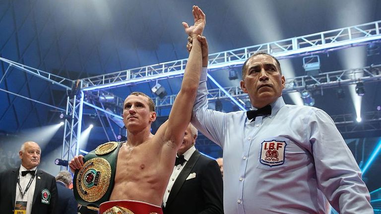 Troyanovsky celebrates as he retains his IBF and IBO world titles