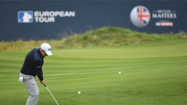 WATFORD, ENGLAND - OCTOBER 13:  Tyrrell Hatton of England plays his third shot on the 18th hole during the first round of the British Masters at The Grove 