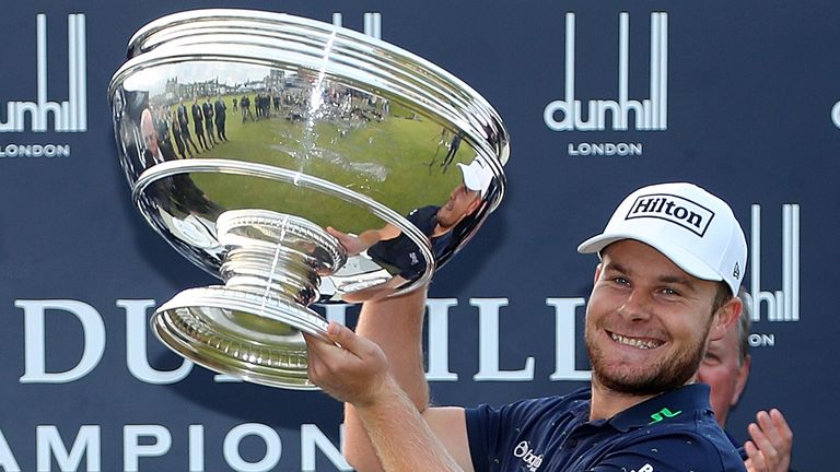 Tyrrell Hatton holds aloft the Alfred Dunhill Links Championship trophy