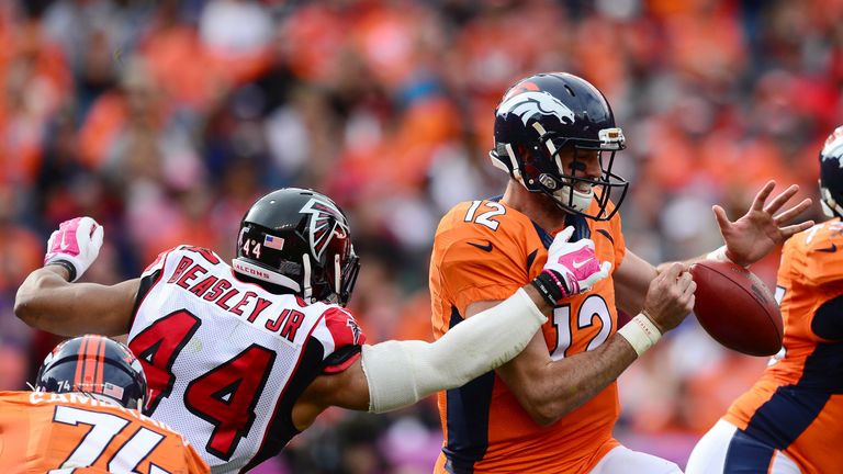 DENVER, CO - OCTOBER 9:  Quarterback Paxton Lynch #12 of the Denver Broncos loses the ball while pursued by  outside linebacker Vic Beasley #44 of the Atla