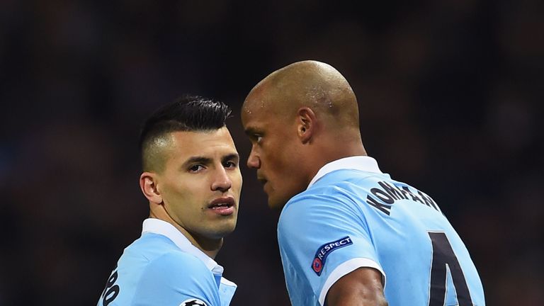 MANCHESTER, ENGLAND - MARCH 15:  An injured Vincent Kompany of Manchester City (4) speaks to Sergio Aguero of Manchester City as he leaves the pitch during